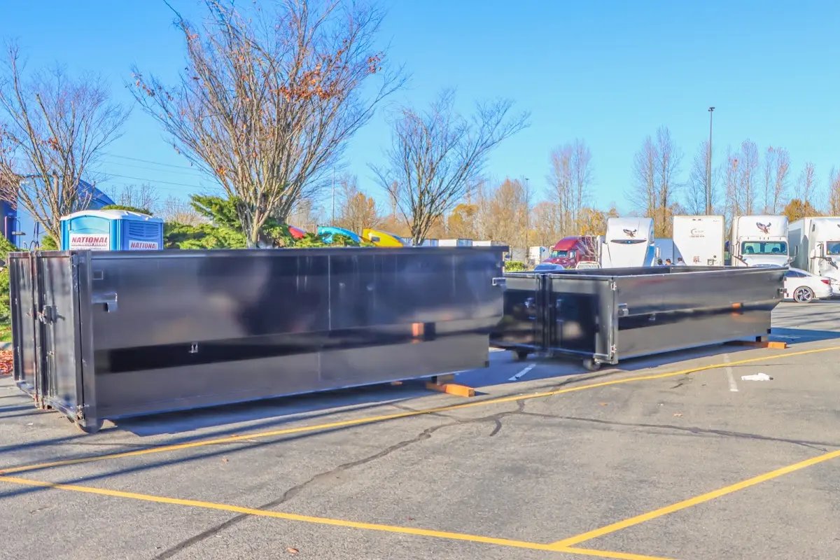 Professional dumpster rental service with roll-off container on residential driveway in Kingstowne
